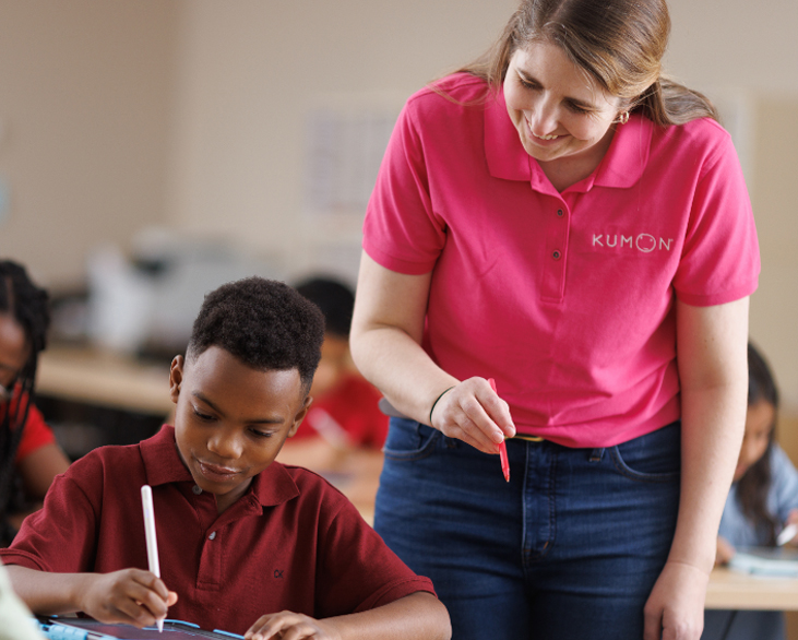 Instructor overseeing a student practing on their tablet